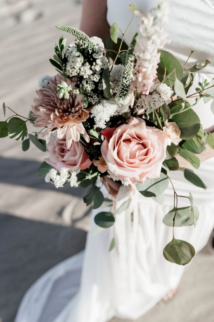 bridal bouquet with light pink green and white florals in desert by katherine krakowski photography a lake tahoe reno photographer