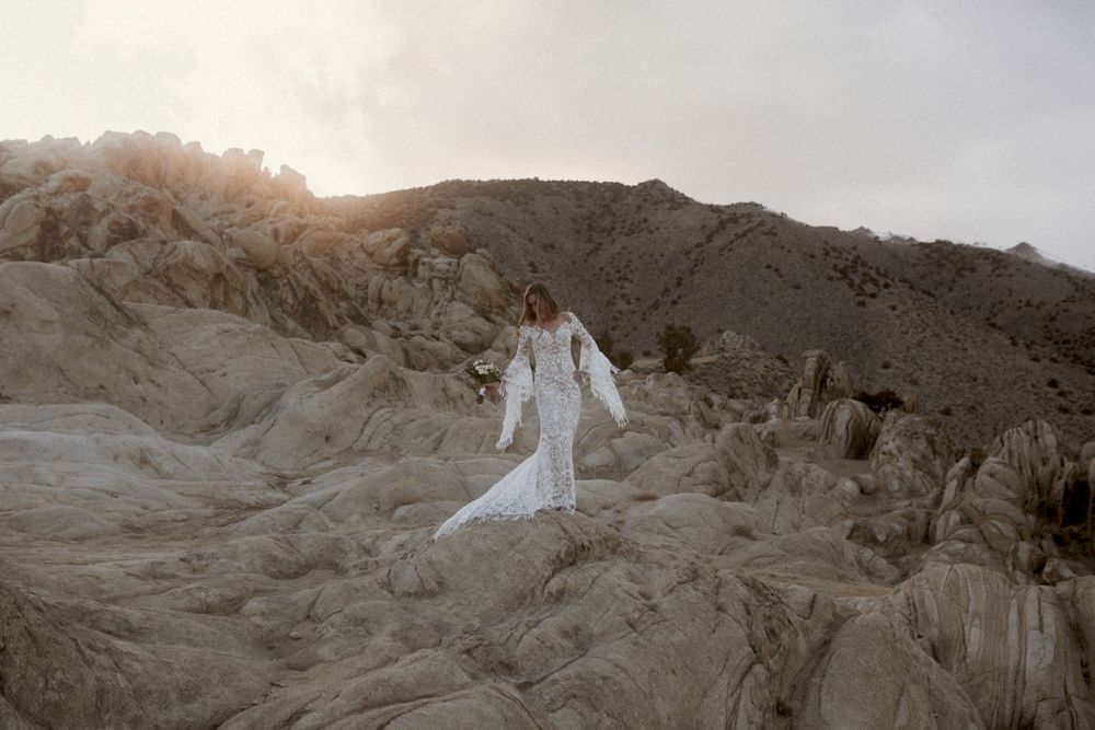boho bride standing on rocks in reno nevada desert